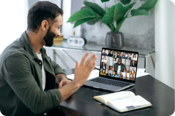 A man waving to his colleagues on a Zoom video conference